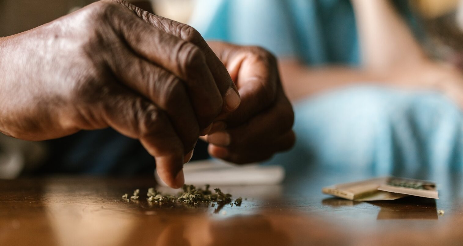 hands grinding up cannabis flower